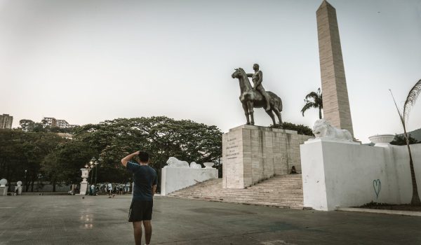 a man standing near the statue